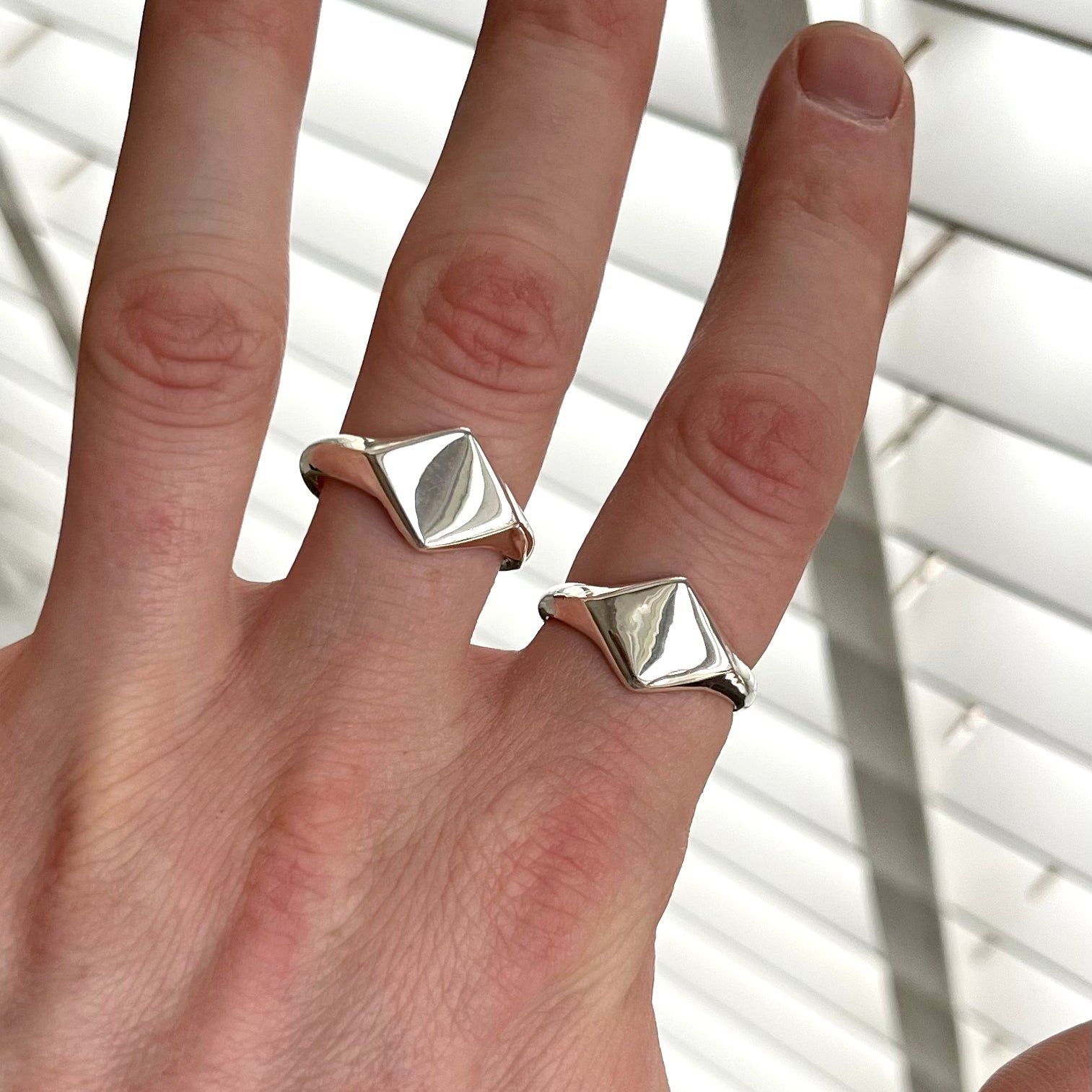 two silver rings on a hand 